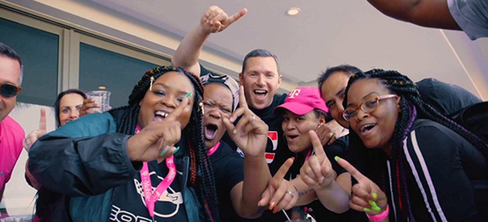 A group of enthusiastic T-Mobile employees and customers.